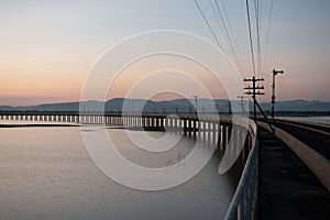 Landscape View of  Train crossing Pasak Chonlasit Dam. Reservoir for agriculture at Lopburi,Thailand