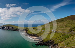 Landscape view of the turquoise waters and golden sand beach at Slea Head on the Dingle Peninsula of County Kerry