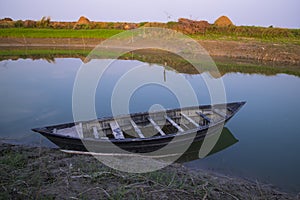 Landscape View of a wooden boat on the bank of the Padma river