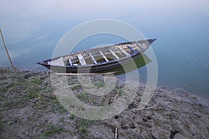 Landscape View of a wooden boat on the bank of the Padma river