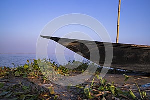 Landscape View of a wooden boat on the bank of the Padma river