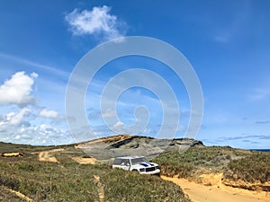 Landscape views of PapakÃÂlea Green Sand Beach,Naalehu, Hawaii,United States on bright sunny days.dirt road against blue sky.