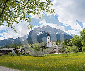 Landscape village church and cemetery Obergrainau, Wetterstein Mountains in spring