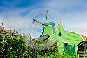 Landscape of a village with a windmill and a house. Famous Dutch Landscape - Agricultural Historical Landscape. Tourism