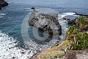 Landscape of a volcanic coast with black rocks, Atlantic ocean. Selective focus. Los Gigantes, Tenerife