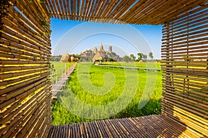 Landscape of Wat Tham Sua Temple Tiger Cave Temple with Jasmine rice fields and bamboo frame at Kanchanaburi Province