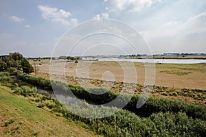 Landscape with water canal in the Netherlands Colorful blue sky with clouds. Spring landscape in Holland. Rural scene. Cloudy sky