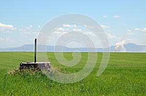 Landscape with a water well and fume