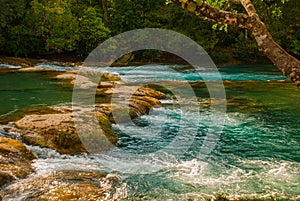 Landscape with waterfall Agua Azul, Chiapas, Palenque, Mexico. Huge stones on which water flows.