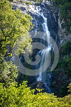 Landscape of waterfall with flowing water inside the tropical rainforest in Thailand