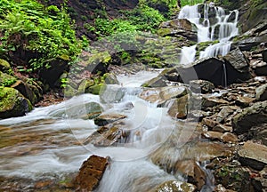 Landscape of waterfall Shypit in the Ukrainian Carpathian Mountains on the long exposure in summer morning. Zakarpattya, Ukraine