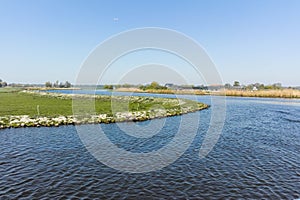 Landscape with waterways and canals of North Holland with boats, canal-side lifestyle in the Netherlands