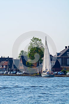 Landscape with waterways and canals of North Holland with boats, canal-side lifestyle in the Netherlands