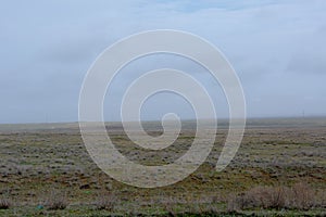 Landscape of wild Kalmyk steppe in a fog