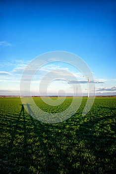 Landscape with wind turbines and shadows of people