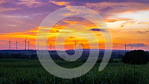 Landscape Windmill on a mountain with vast meadows at sunset, beautifully illuminated
