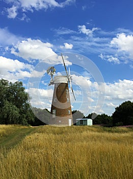 Landscape with windmill in a wheat field in Britain