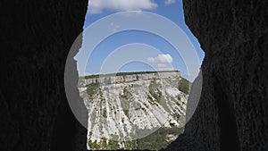 Landscape through the windows cut into the rock. Chufut-Kale is a cave city.