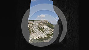 Landscape through the windows cut into the rock. Chufut-Kale is a cave city.