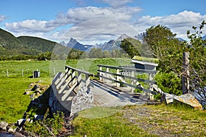 Landscape of wooden bridge in remote green countryside of Bodo in Nordland, Norway. Infrastructure and built crossing in