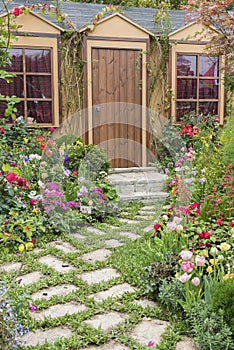 Landscaped backyard of house with flower garden