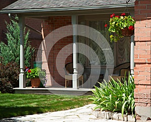 Landscaped front yard of a house with flowers and green lawn