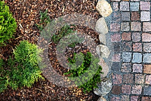 landscaped garden - mulched flower bed and granite cobblestone path