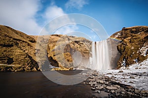 Landscaped, Skogafoss waterfall with rainbow in beautiful day at Iceland