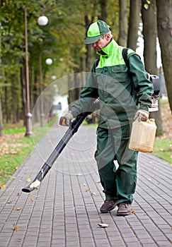 Landscaper cleaning the track using Leaf Blower