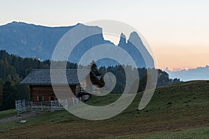 Landscapes on Alpe di Siusi with small cabins on grassland in autumn, South Tyrol, Italy