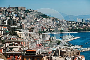 Landscapes of Naples; the coast of the city with houses on the mountain and with boats in the sea