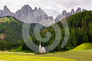 Landscapes with San Giovanni Church and small village in Val di Funes. Dolomite Alps, South Tyrol. Italy