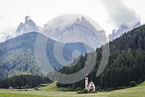 Landscapes with San Giovanni Church and small village in Val di Funes, Dolomite Alps, South Tyrol, Italy, Europe