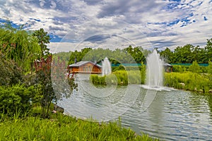 Landscaping. Beautiful pond with fountain in green park at Mezhgorye residence, Ukraine