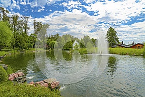 Landscaping. Beautiful pond with fountain in green park at Mezhgorye residence, Ukraine