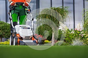 Landscaping Garden Keeping Worker Mowing Back Yard Lawn