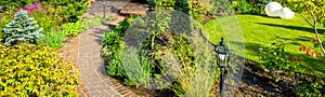 Landscaping in nice green garden in summer. Panoramic view of landscaped place at residential house