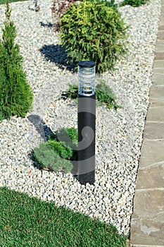 Landscaping in a private yard. Natural stone sidewalk and green lawn