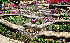 Landscaping with retaining walls and flowerbeds in residential house backyard