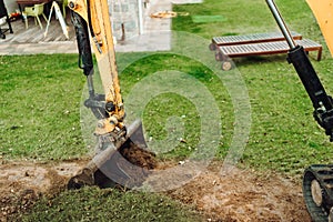 Landscaping works with bulldozer and excavator at home construction site. Terrain works