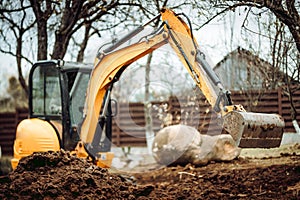 Landscaping works with mini excavator at home construction site. Terrain works photo