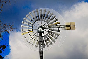 Landschaftspark Duisburg, Germany: Close up of isolated wind wheel against blue sky and clouds