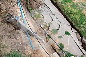 Landslide environmental disaster due to asphalt road fell down.