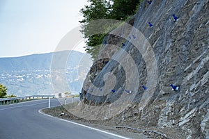 Landslide and rock sliding prevention in Georgia, reinforcing mountain slope with metal mesh.