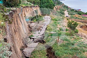 Landslides cracks in the asphalt road after a geological natural disaster.