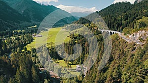 Landwasser Viaduct in Swiss Alps in Summer, Aerial view on Green Mountain Valley