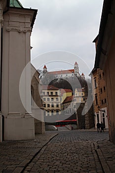 Lane near St Martin`s Cathedral with Bratislava castle in background photo
