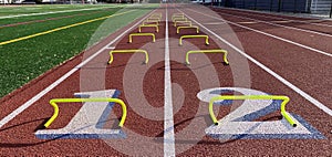 Lanes 1 and 2 of a track set up with small mini hurdles for runners to run over