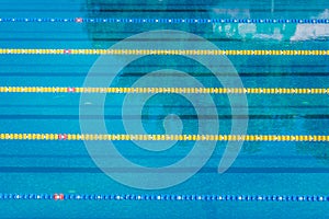 Lanes in a competition olympic size outdoor swimming pool. Calm Water background.