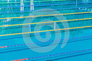 Lanes in a competition olympic size outdoor swimming pool. Calm Water background.